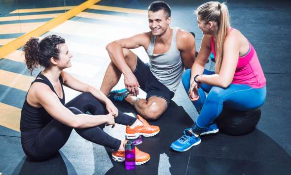 group-happy-athletic-people-sitting-floor-after-workout-health-club