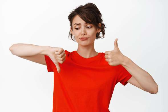 unsure-young-woman-making-choice-show-thumbs-up-thumbs-down-being-indecisive-say-no-yes-judging-smth-standing-white